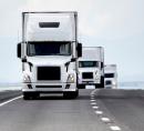 picture of a fleet of trucks driving along the highway